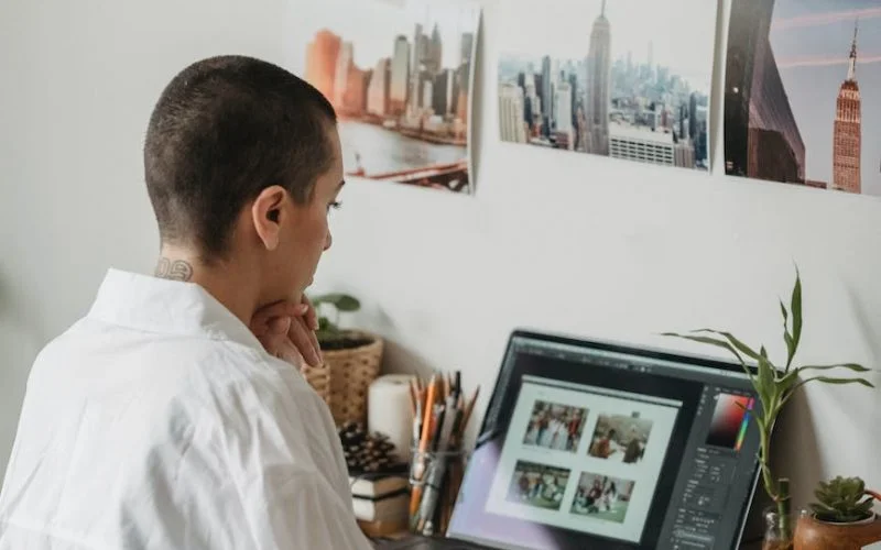 serious woman editing photos on laptop